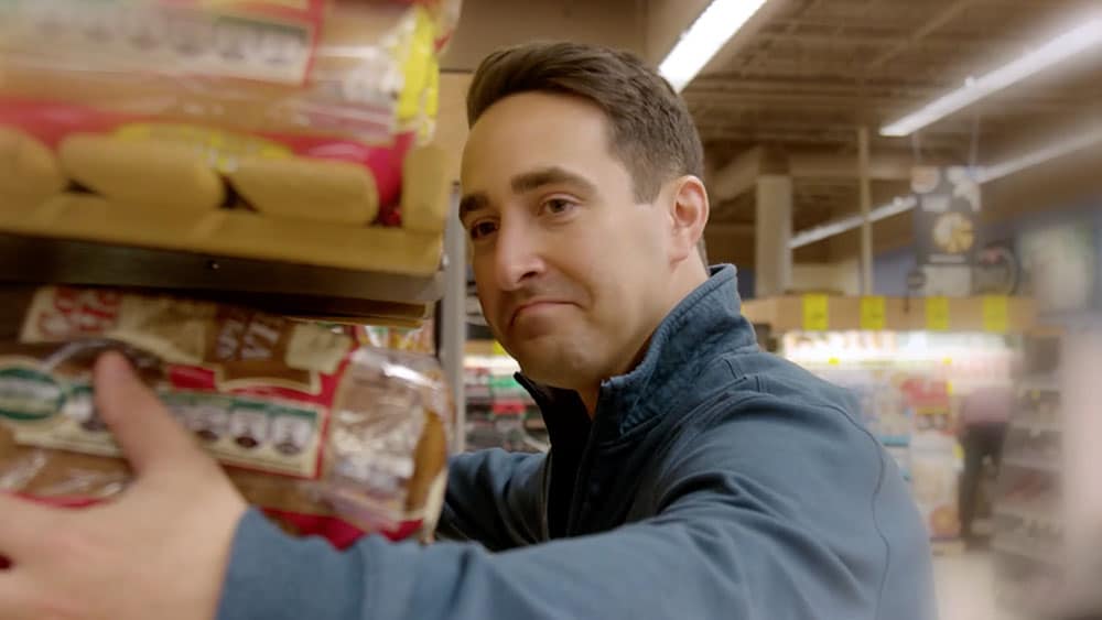 Man hugging Country Hearth bread