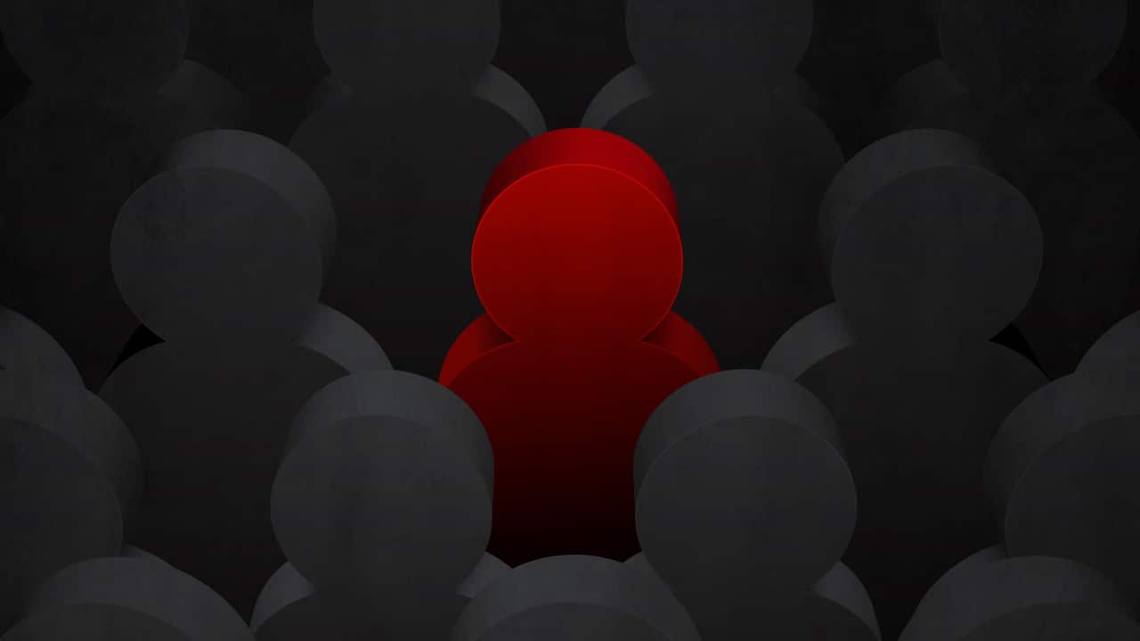 A moody graphic of a red figure standing out amidst a sea of black silhouettes.