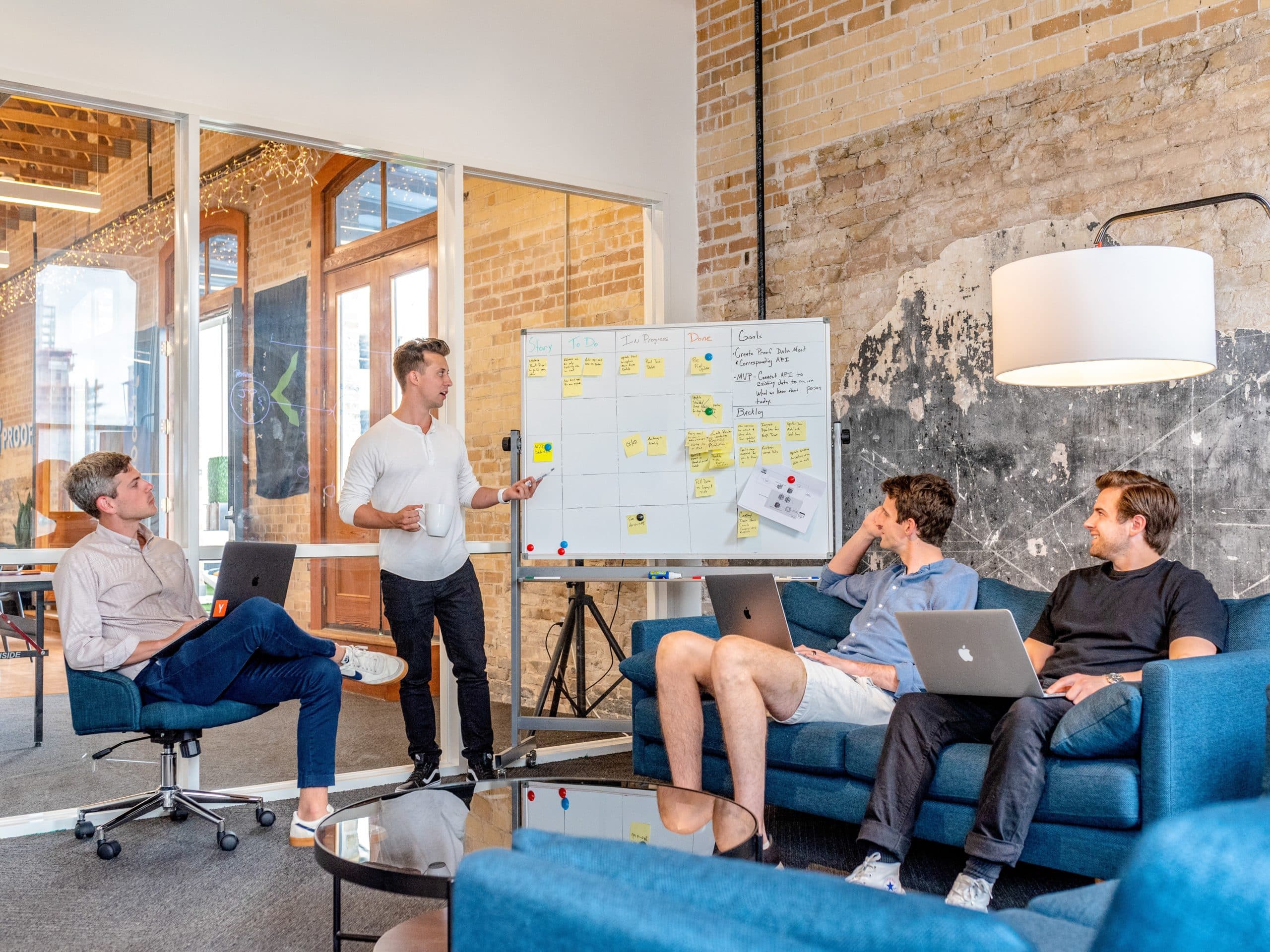 A group of young business professionals meet in a co-op office space.