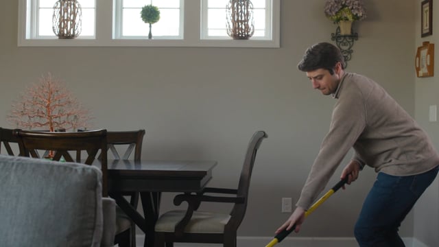 man using the Simple Scrub mop in his house
