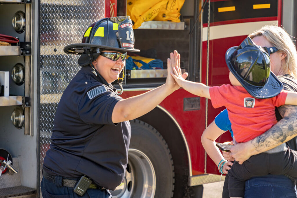 A firefighter greeting a child